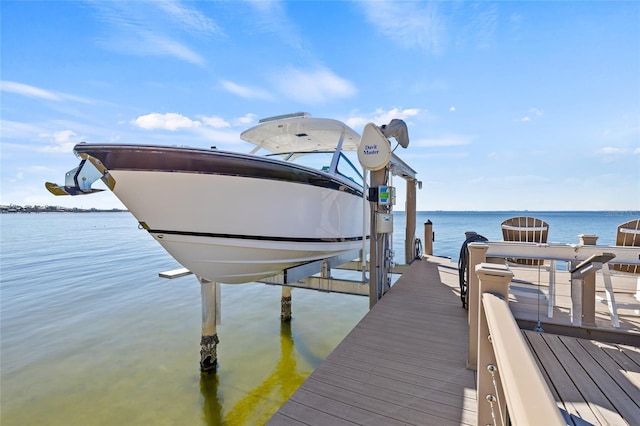 dock area with a water view and boat lift