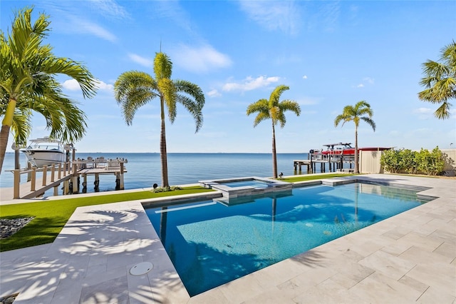 view of swimming pool with a boat dock, a water view, boat lift, and a pool with connected hot tub