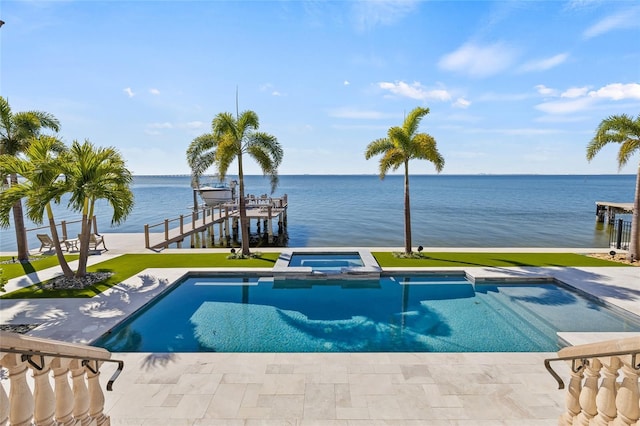 view of pool featuring a patio, a boat dock, boat lift, a water view, and a pool with connected hot tub