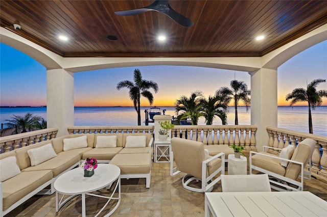 view of patio featuring a ceiling fan, outdoor lounge area, and a water view