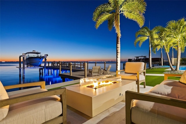 exterior space featuring an outdoor living space with a fire pit and a water view