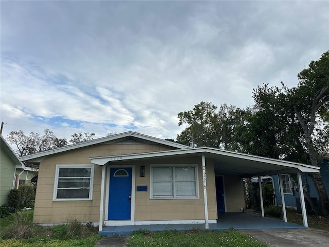 view of front of house with an attached carport and concrete driveway