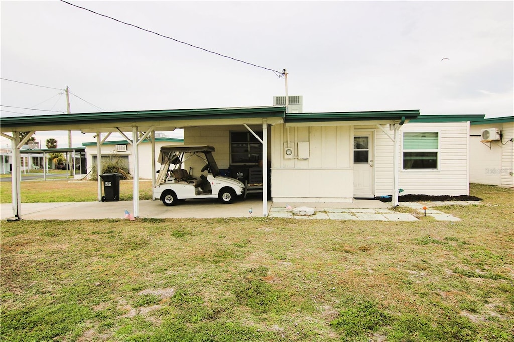 exterior space with an attached carport and a yard