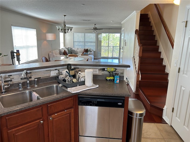 kitchen with a sink, open floor plan, ornamental molding, stainless steel dishwasher, and dark countertops