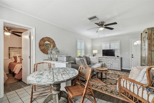 dining room with light tile patterned floors, ceiling fan, and visible vents