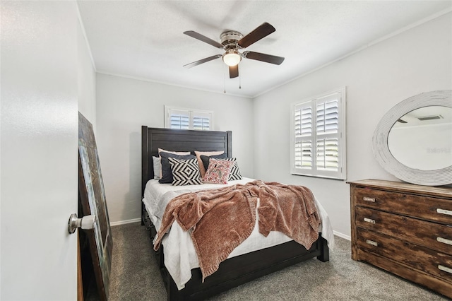 carpeted bedroom with ornamental molding, ceiling fan, and baseboards