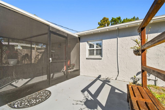 view of patio with a sunroom