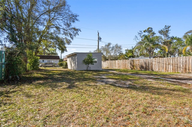 view of yard with an outbuilding and fence