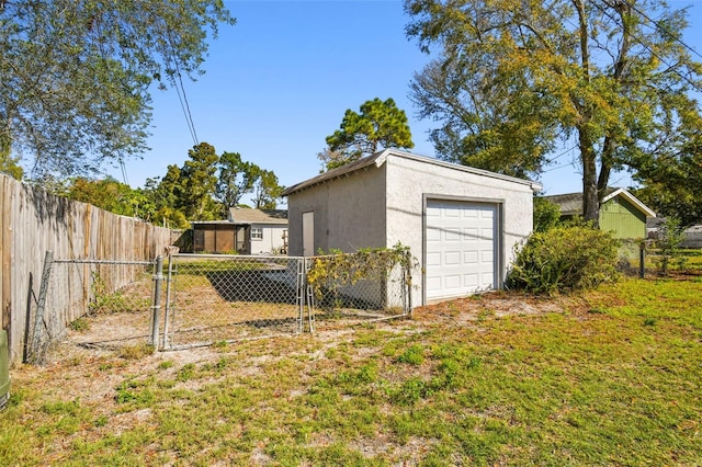 detached garage featuring a gate and fence