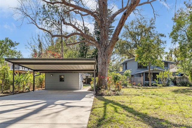 mid-century modern home with a carport, driveway, and a front lawn