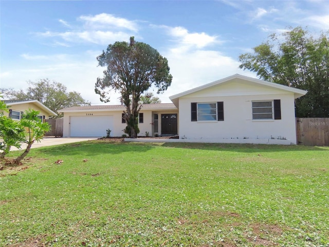 ranch-style house featuring a garage, driveway, a front lawn, and fence