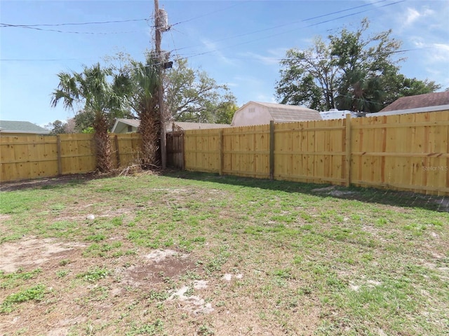 view of yard with a fenced backyard