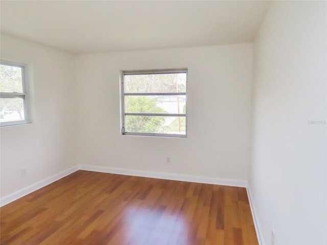 empty room with wood finished floors and baseboards