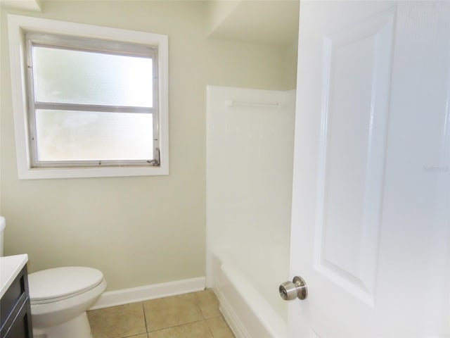 bathroom with tile patterned flooring, toilet, vanity, baseboards, and a shower