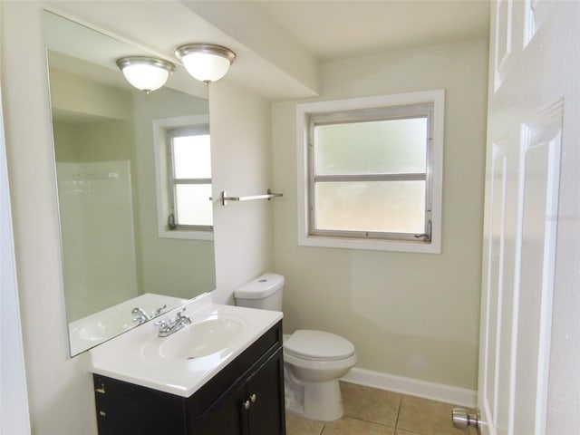 bathroom featuring baseboards, vanity, toilet, and tile patterned floors