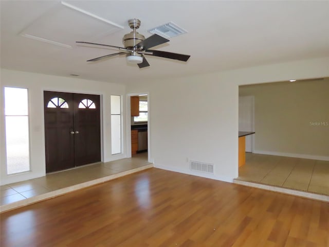 entryway with a ceiling fan, baseboards, visible vents, and wood finished floors