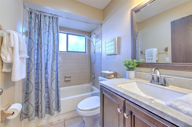 bathroom featuring shower / bath combo, vanity, toilet, and tile patterned floors