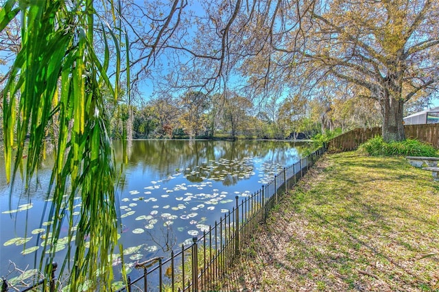 property view of water featuring fence