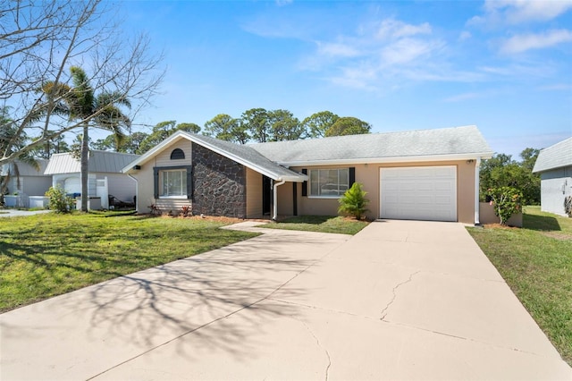 view of front of property with driveway, stucco siding, a garage, and a front yard