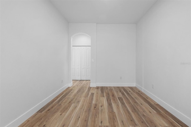 unfurnished room with light wood-style flooring and baseboards