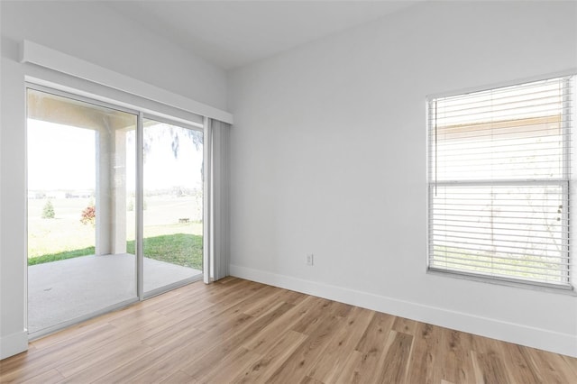 unfurnished room with light wood-style floors and baseboards