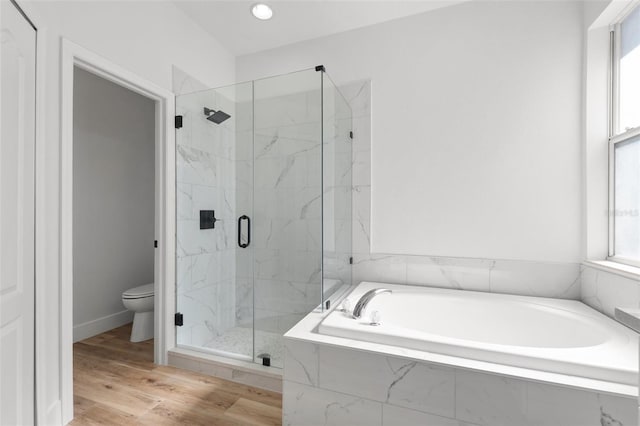 full bath featuring toilet, a garden tub, a marble finish shower, and wood finished floors