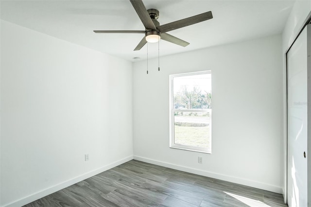 spare room with ceiling fan, baseboards, and wood finished floors