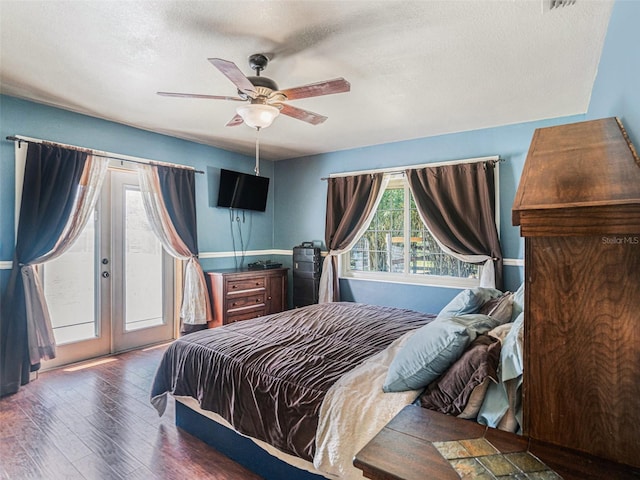 bedroom with ceiling fan, a textured ceiling, wood finished floors, access to outside, and french doors