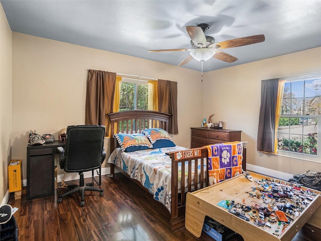 bedroom with a ceiling fan, baseboards, and wood finished floors