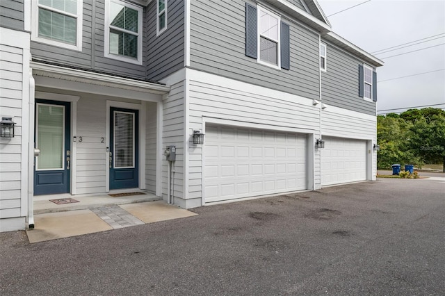 exterior space with driveway and an attached garage