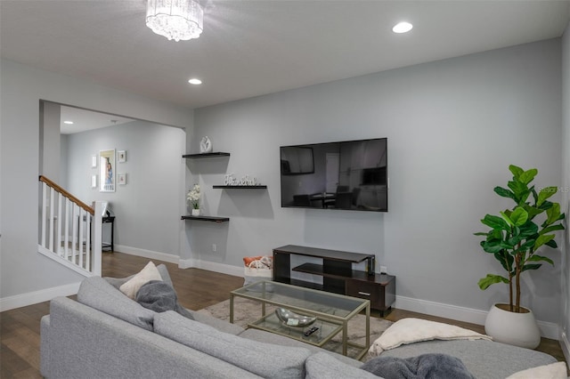 living room featuring recessed lighting, stairway, baseboards, and wood finished floors