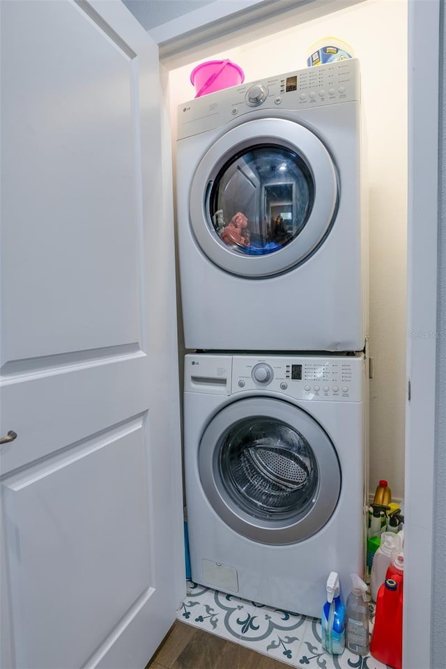 washroom featuring stacked washing maching and dryer and laundry area