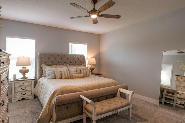 bedroom featuring light carpet, ceiling fan, a textured ceiling, and baseboards