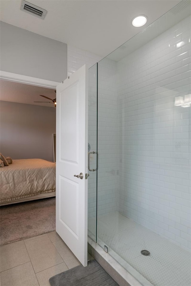 ensuite bathroom featuring visible vents, a ceiling fan, connected bathroom, a shower stall, and tile patterned floors