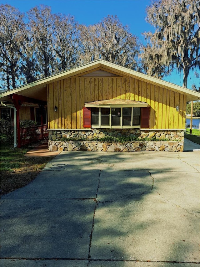 view of front of property with stone siding and board and batten siding