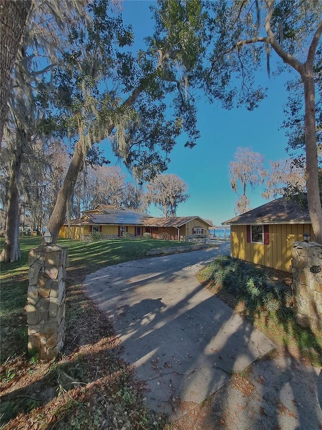 view of road with concrete driveway