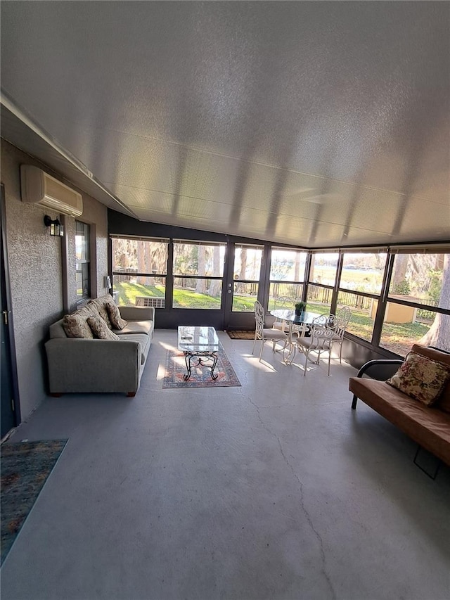 sunroom with a wall mounted air conditioner and a wealth of natural light