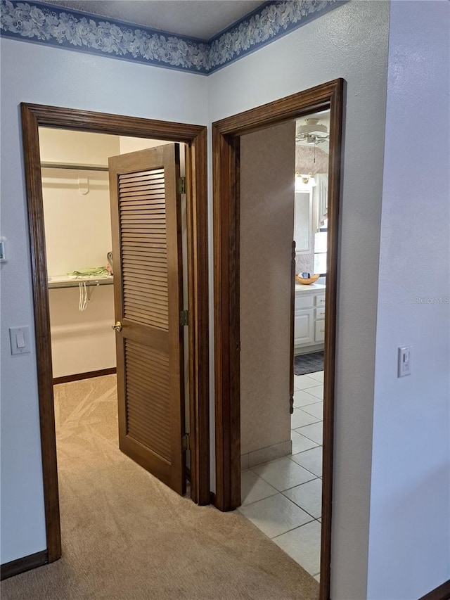 hallway with light carpet and baseboards