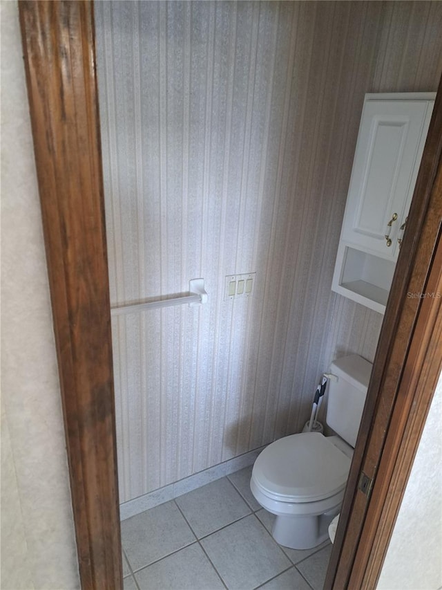 bathroom with toilet and tile patterned floors