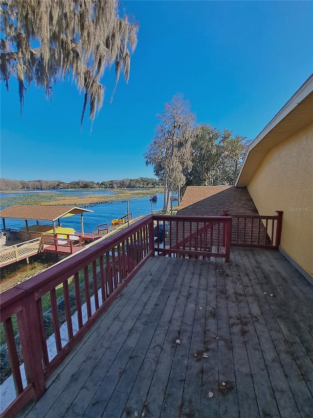 wooden terrace featuring a water view