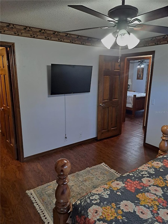 bedroom featuring dark wood-style floors, ceiling fan, and baseboards