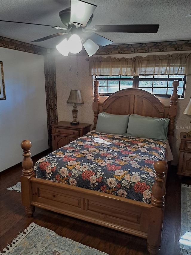 bedroom with a ceiling fan, a textured ceiling, and wood finished floors