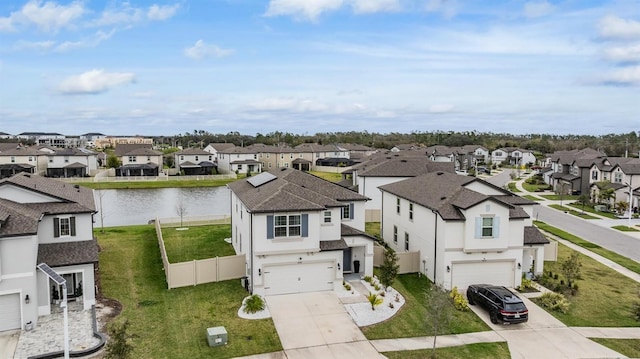 birds eye view of property with a water view and a residential view