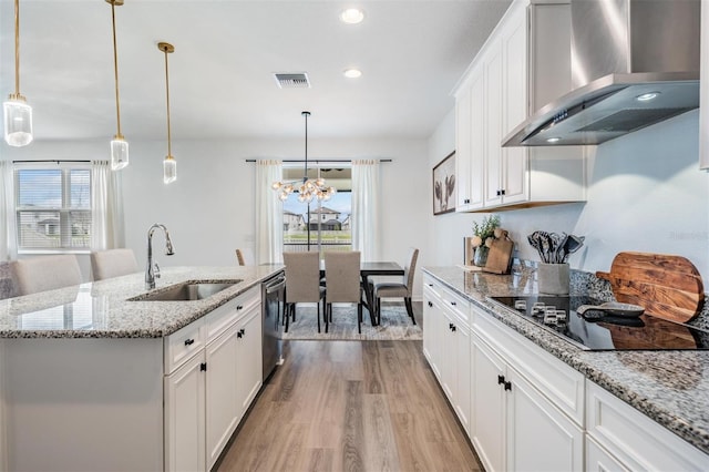 kitchen with black electric stovetop, visible vents, a sink, dishwasher, and wall chimney exhaust hood