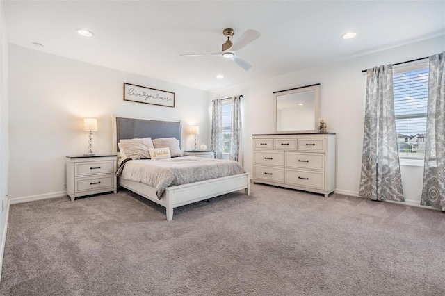 bedroom featuring multiple windows, baseboards, and carpet flooring