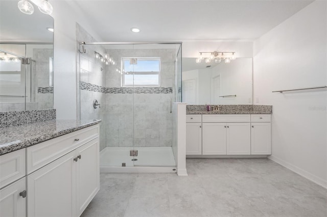 full bath with two vanities and a shower stall