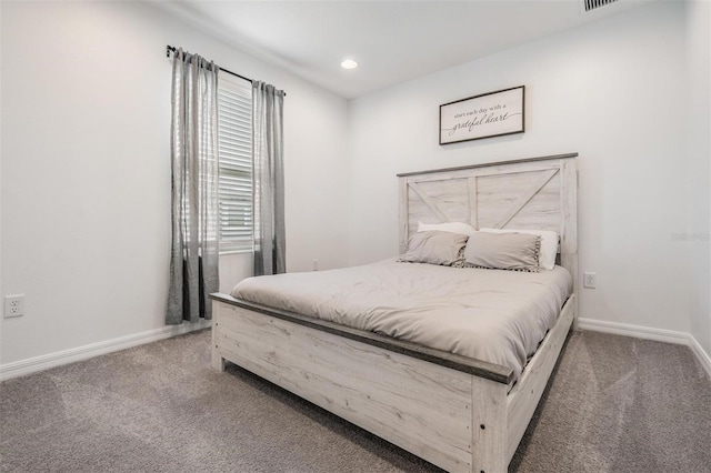 carpeted bedroom featuring baseboards and recessed lighting