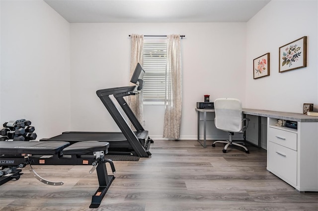 office area featuring baseboards and wood finished floors