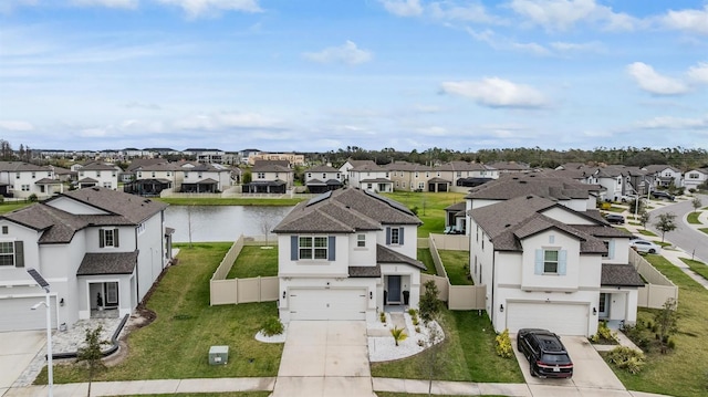 drone / aerial view with a water view and a residential view