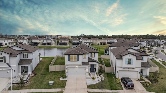 bird's eye view featuring a water view and a residential view